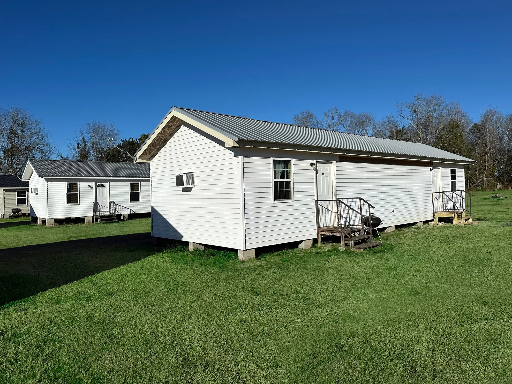 Rental cabins on the green lawns at Vogtle Ranch
